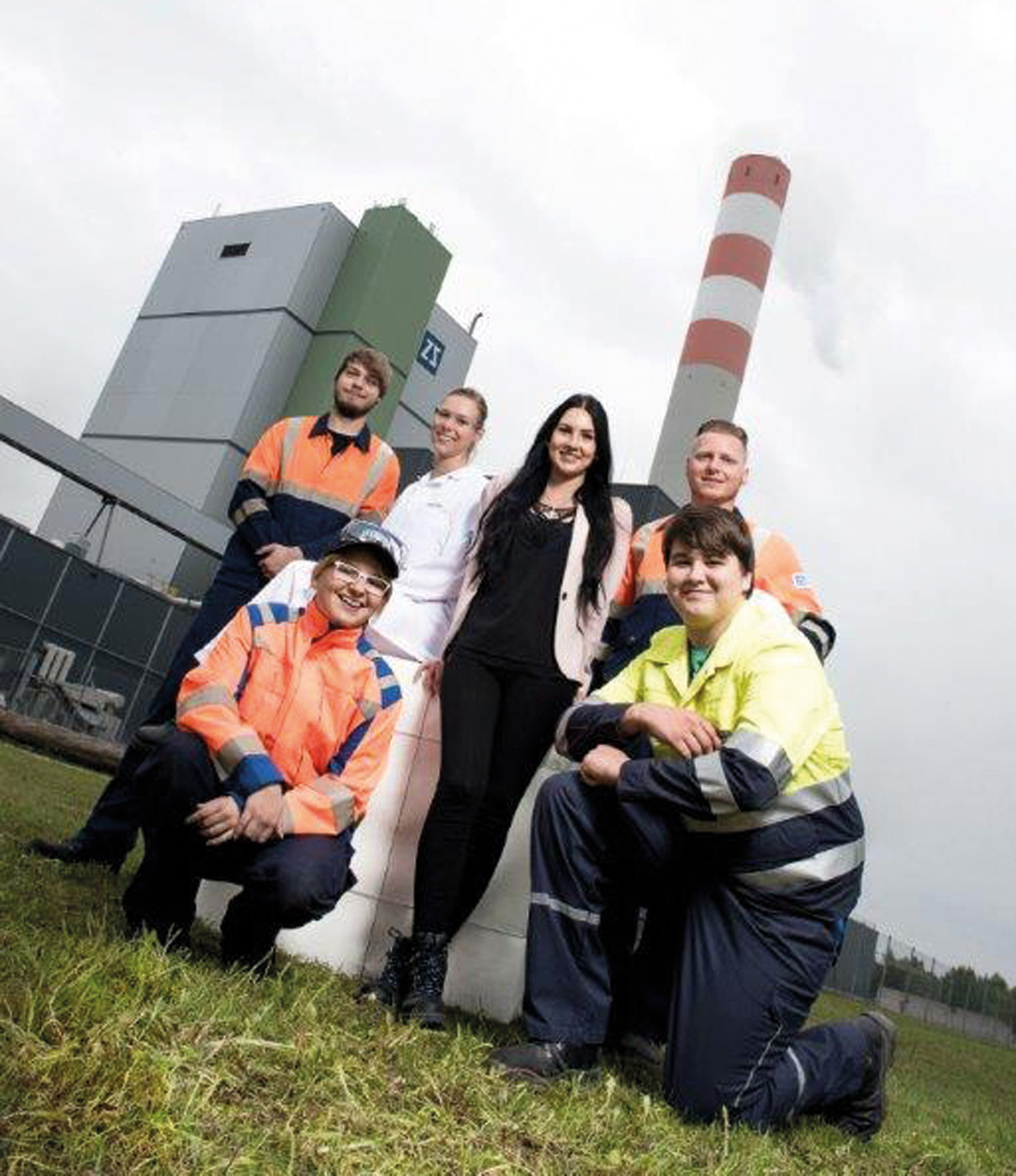 Junge Menschen vor einem Industriegebäude